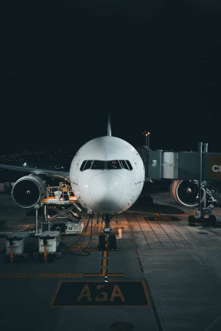 white airplane on airport during night time
