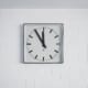 white round analog wall clock at 10 00